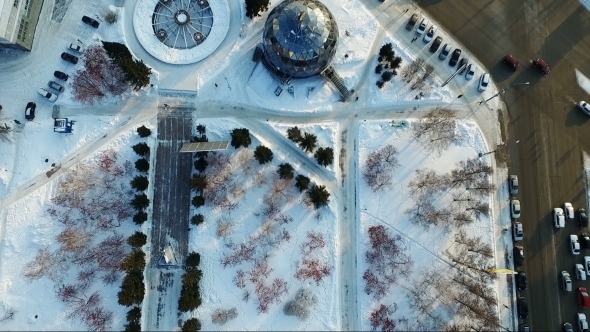 Flying Over The City Park In Winter. Spherical Building. Car Traffic