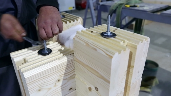 Profiled Glued Bars. View Of Man Tightens Fastener