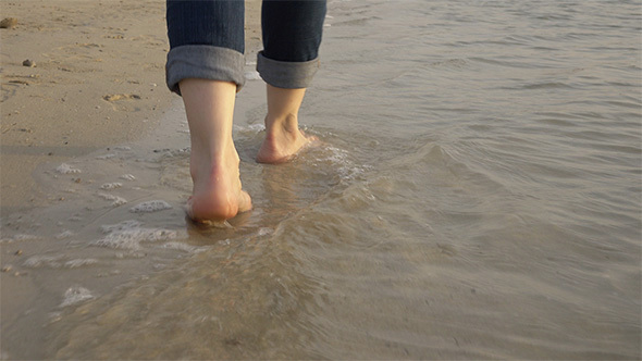 Girl Walking Along the Water's Edge alt