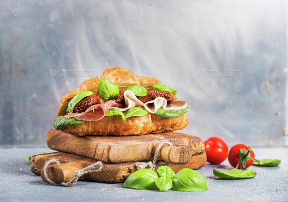 Croissant sandwich with smoked meat Prosciutto di Parma