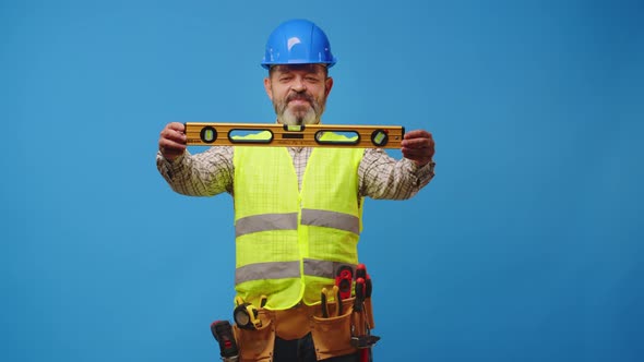 Senior Man Foreman Holding Tool Againast Blue Background