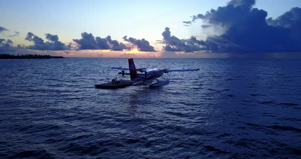 Tropical above travel shot of a summer white paradise sand beach and aqua blue water background in h alt