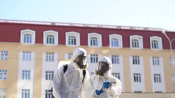 Brave Cleaning Service Workers in Biosecurity Suit, Mask and Gloves, Carries Out Disinfection From alt