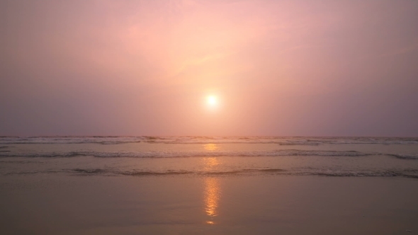 Sunset On The Beach, Waves Slowly Splashing On The Sand