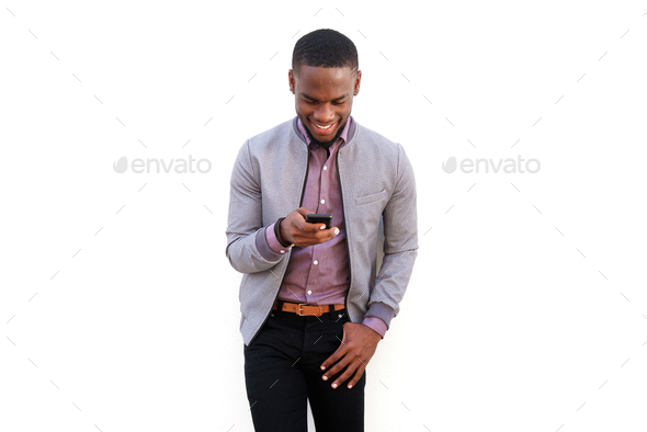Happy young black man sending text message - Stock Photo - Images