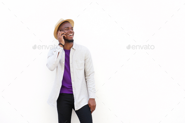 Cheerful young african guy talking on cell phone