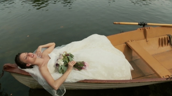 Beautiful Bride Lying In The Boat On The Lake. Paris, France