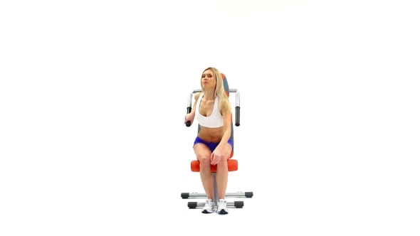 Slender Blonde Shows Exercise On Trainer