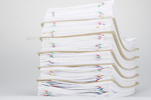Overload of paperwork and brown envelope with colorful paperclip