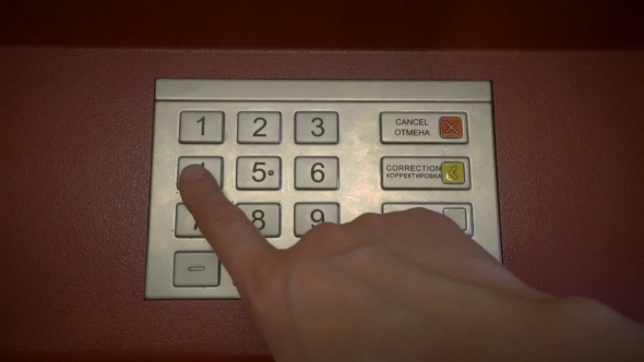 Finger Entering Secret Pin Number At ATM 