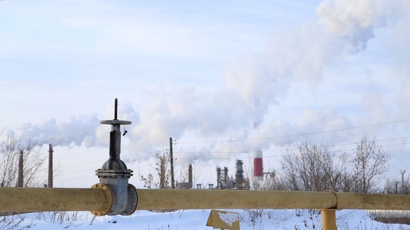 Large Valve of the Gas Pipe, the Smoke Comes from the Chimneys alt