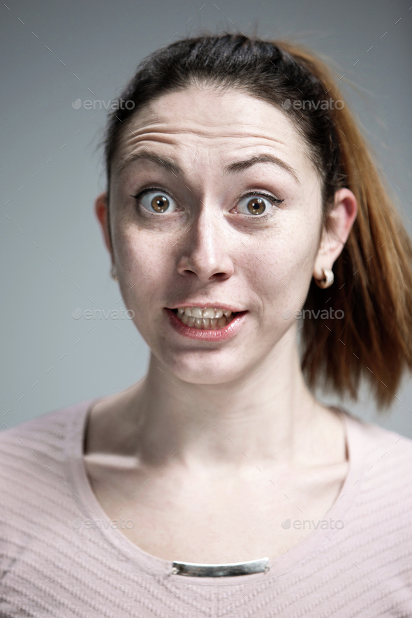 Portrait of young woman with shocked facial expression Stock Photo by ...