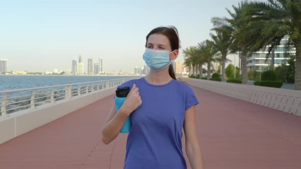  Girl in Medical Mask on the Promenade