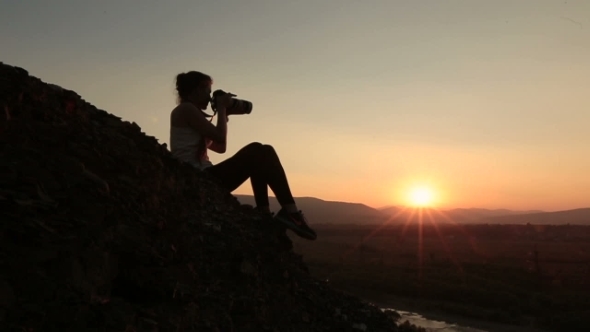 Silhouette Of Woman-Photographer Taking Photos Of Sunset In The Alpine Mountains