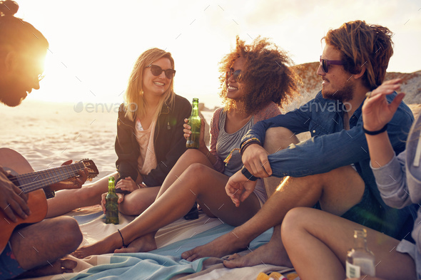 Young friends partying at the beach - Stock Photo - Images