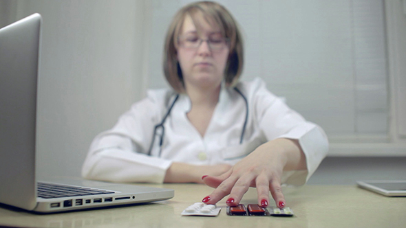 Woman Doctor Taking Pills