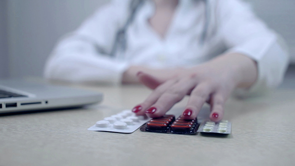 Doctor Fills Out a Medical Form in the Office