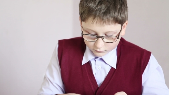Boy With Glasses Playing The Tablet At School alt