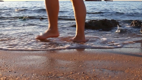 The Woman Barefoot Walks On The Beach