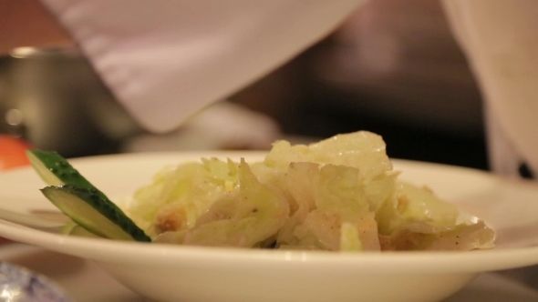 Chef Decorates Salad With Slices Of Chiken