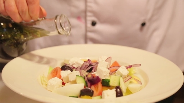 Cook Pours Salad By Sauce