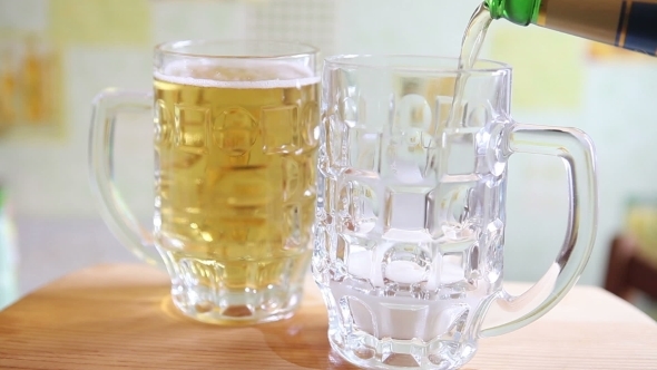 The Beer Is Poured From a Glass Bottle  alt