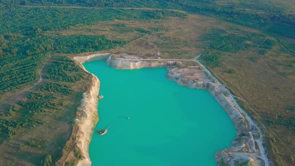 An artificial lake in chalk quarry. view from drone. Turquoise water background alt