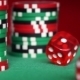 Red Dice Rolls And Casino Chips On Green Table - VideoHive Item for Sale