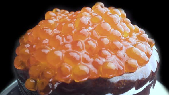 Red Caviar Is Put with a Spoon on Tartlets. Preparation of Snacks with Red Caviar. Close Up