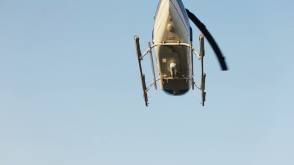 Helicopter Flying In The Clear Blue Sky. Santorini Island, Greece