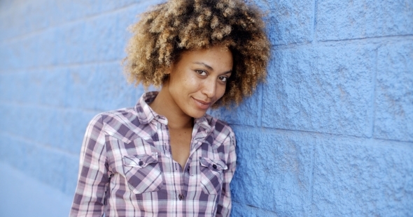 Black Woman Leaning Against Wall alt