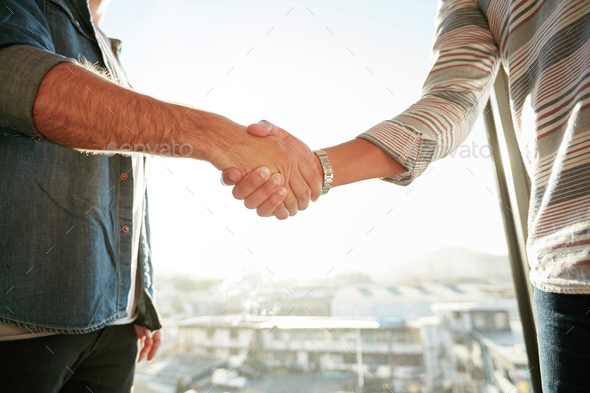 Businesspeople shaking hands in office - Stock Photo - Images