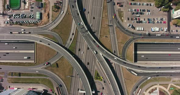 Aerial drone view of highway multi-level junction road with moving cars alt