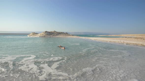 Girl Is Relaxing And Swimming In Water Of Dead Sea In Israel alt