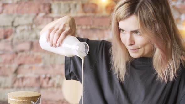 Closeup Portrait Woman Pours Milk From Glass Bottle