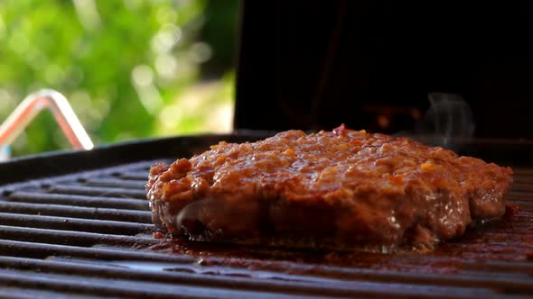 Tasty Thick Beef Cutlet Frying on the Grill alt