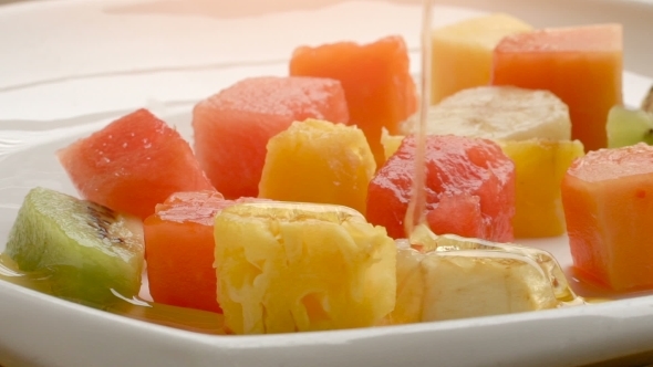 Healthy Fruit Salad With Pouring Honey