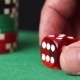Red Dice And Casino Chips In Hand On Green Table - VideoHive Item for Sale