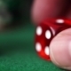 Red Dice In Hand And Casino Chips On Green Table - VideoHive Item for Sale