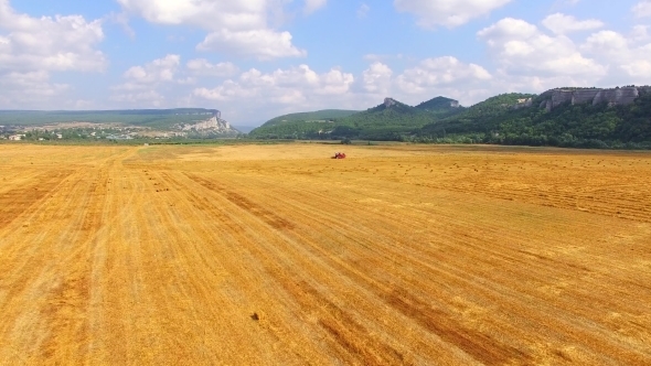 Farm Machinery In The Field Harvesting Wheat