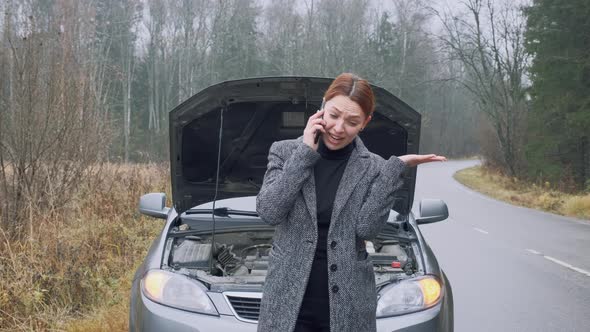 Sad Woman with Phone To Her Ear Start To Crying Near Car alt