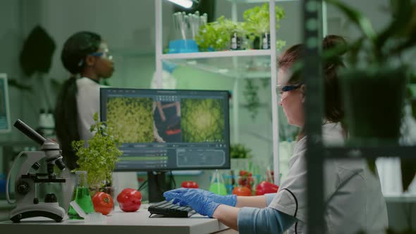 Scientist Woman Researcher Typing Biochemistry Expertise on Computer alt