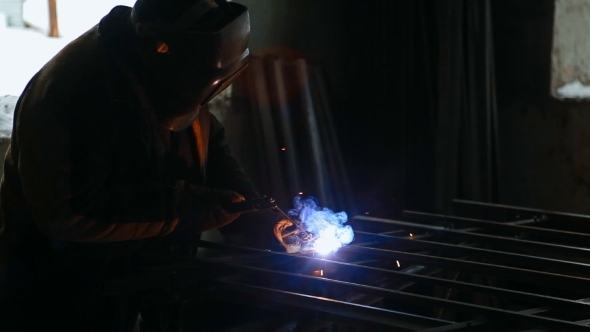 A Welder Is Welding In Winter