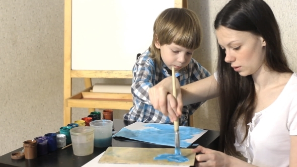Mom And Kid Boy Painting Together At Home