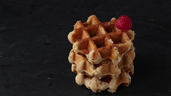 Belgian Waffles With Raspberries And Sugar Powder Over Rusty Surface