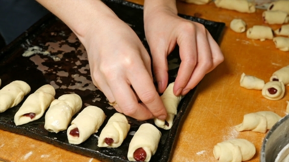 Baker Puts Croissants On The Baking Tray Pan
