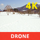 Aerial View of a Snowy Valley from Above in a Sunny Day - VideoHive Item for Sale