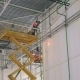 Welder Works On The Orange Lift At a Height In Large And Modern Industry Warehouse - VideoHive Item for Sale
