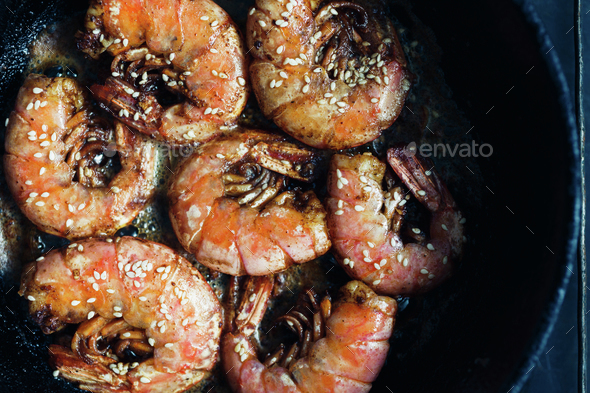 Shrimp fried with garlic and sesame seeds - Stock Photo - Images