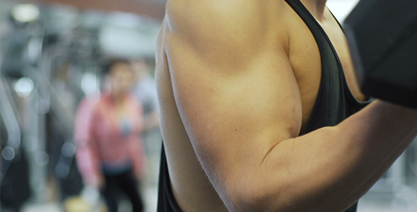 Athlete Trains Biceps Lifting Dumbbells  alt